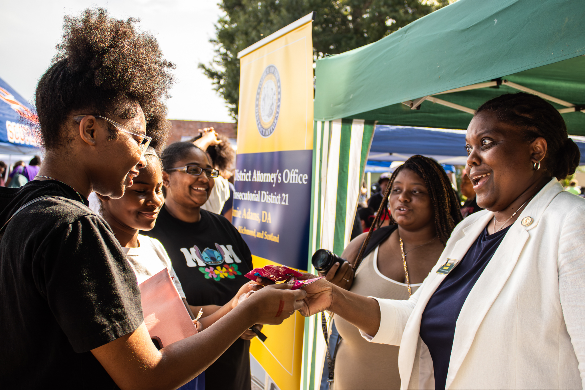 District Attorney Jamie Adams speaking with a family at the annual Scotland county stop the violence event.