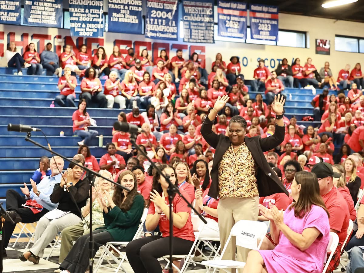 Jamie Adams recieving a round of applause from teachers in Scotland county at their yearly beginning of the year Convocation